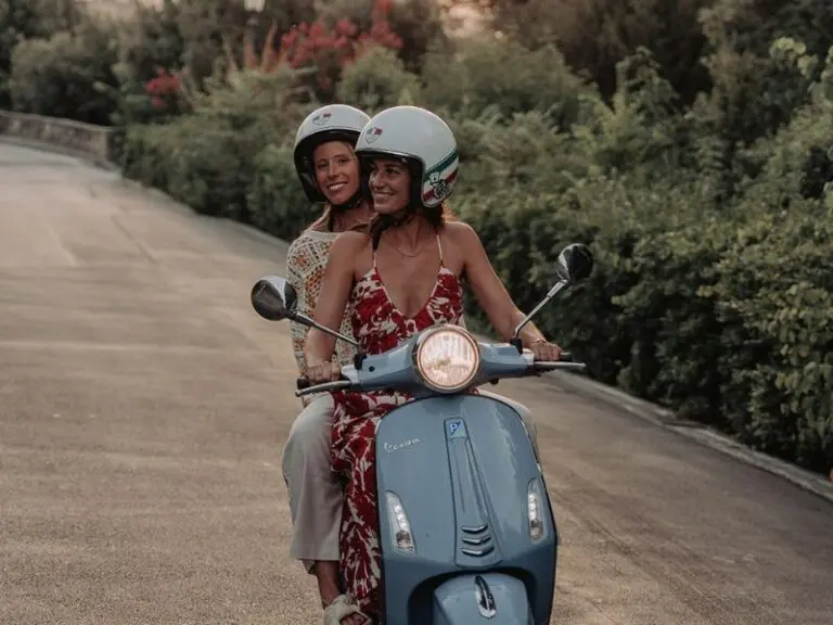 2 girls driving a vespa on a roadtrip in tuscany, 2 meisjes die met een vespa rijden op een rondreis in Toscane