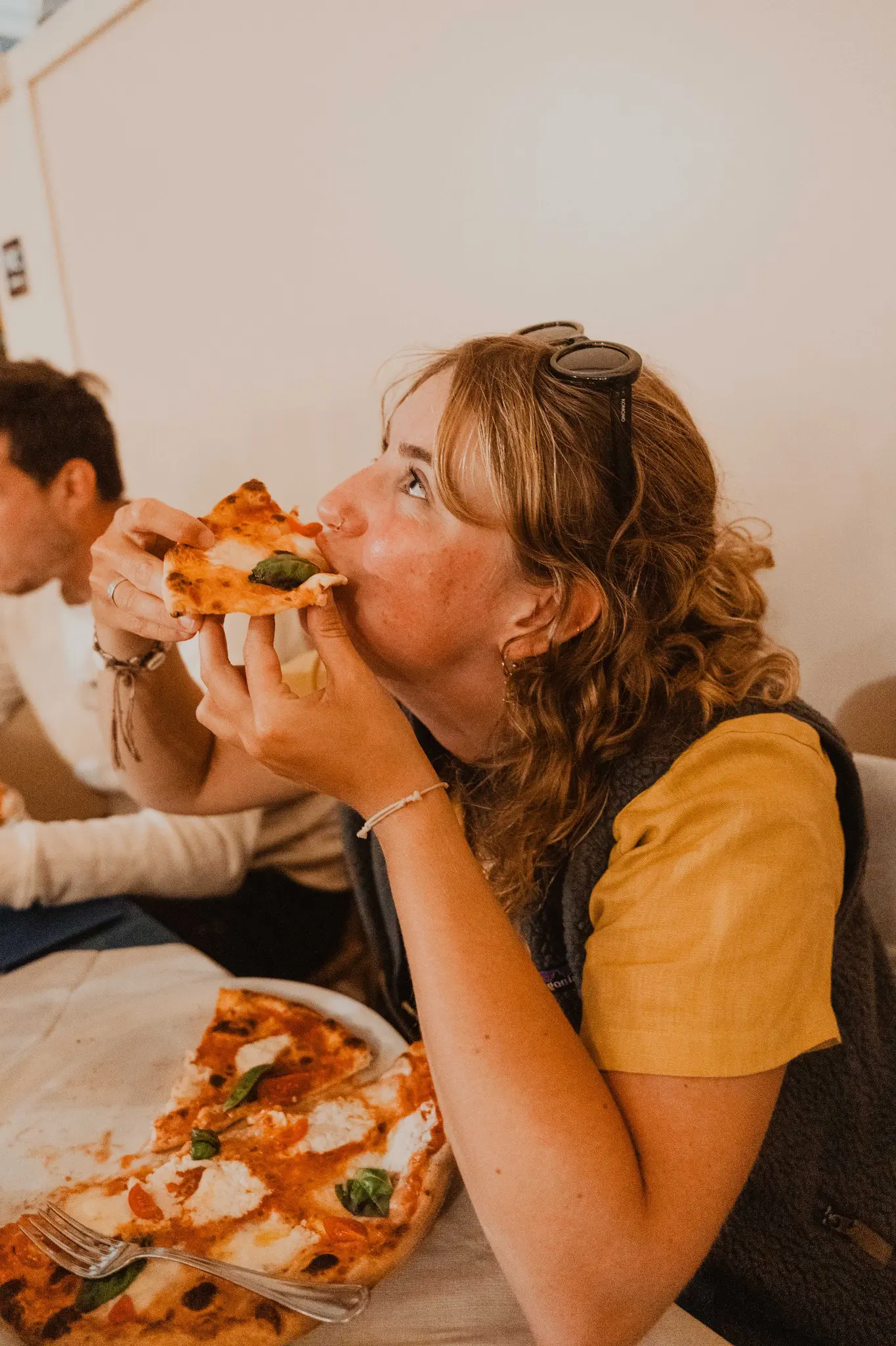 woman eating pizza in Sardinia with friends