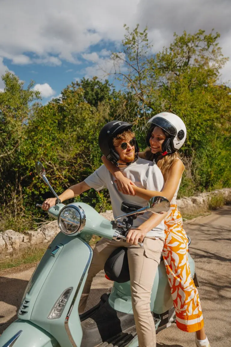 couple on a mint green vespa in Puglia