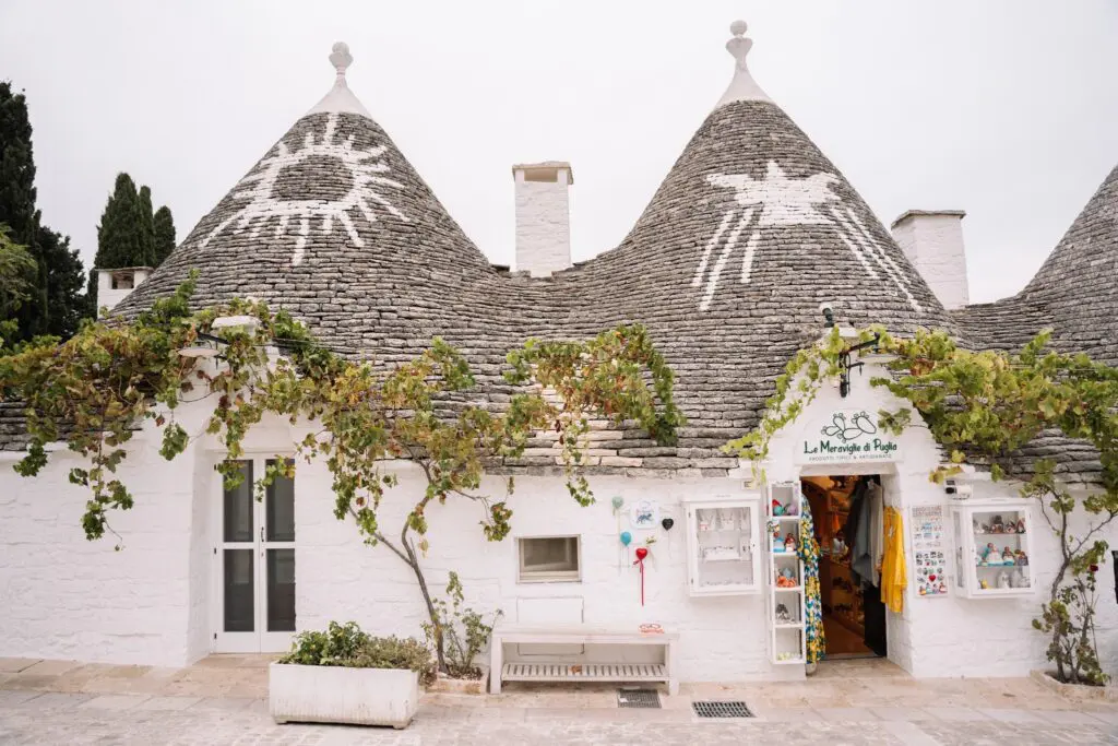traditional trulli houses in Puglia, Italy with shop entrance