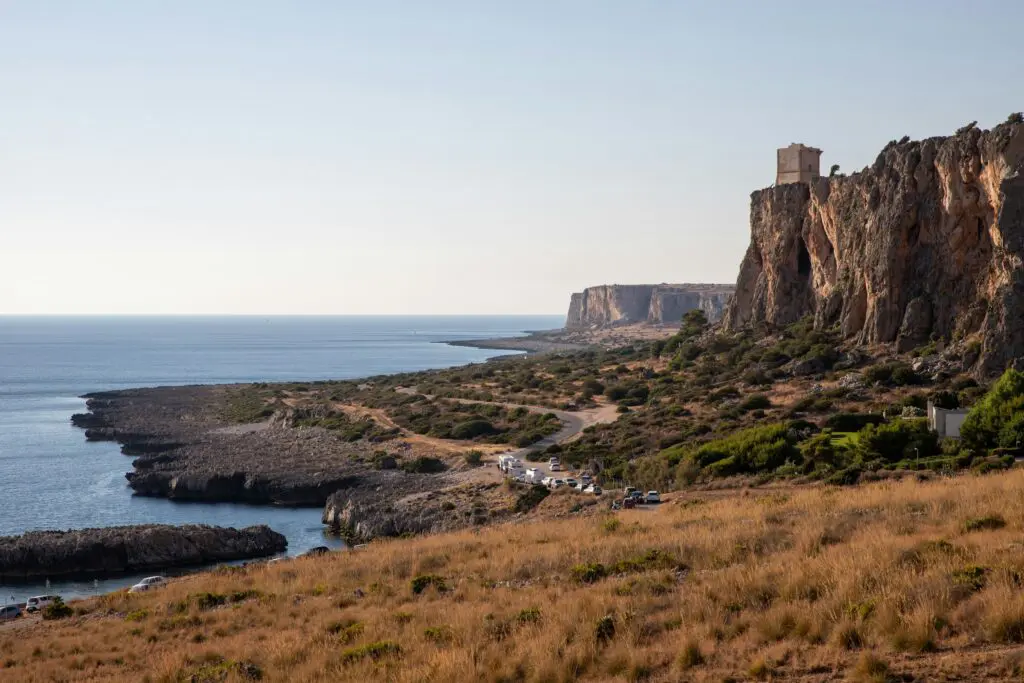 a rocky cliff overlooks a body of water