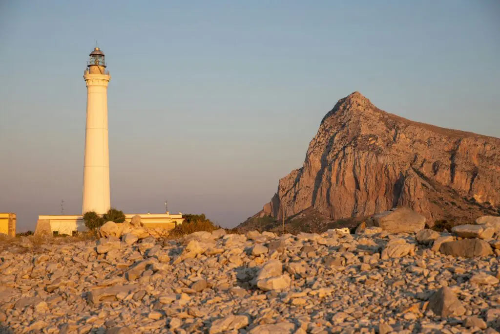 a light house sitting on top of a rocky hill