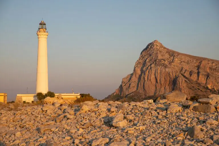 a light house sitting on top of a rocky hill