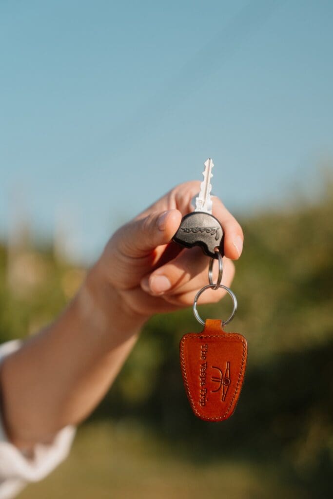 hand holding vespa key with leather keychain