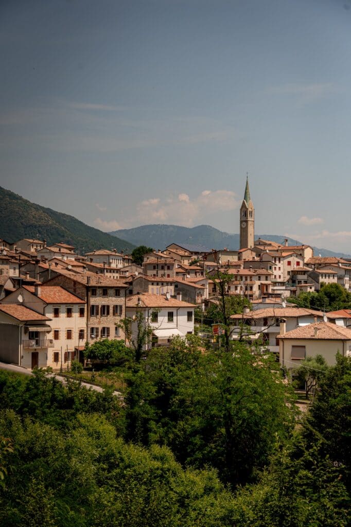 picturesque italian village with a church tower nestled in green hills